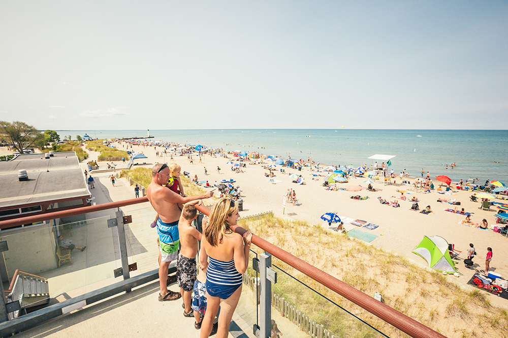 Family overlooking a busy Grand Bend beach 