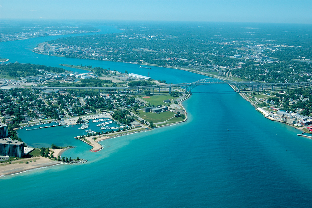 Aerial view of azure blue waters of Lake huron at the mouth of St. Clair River with the Blue Water Bridge