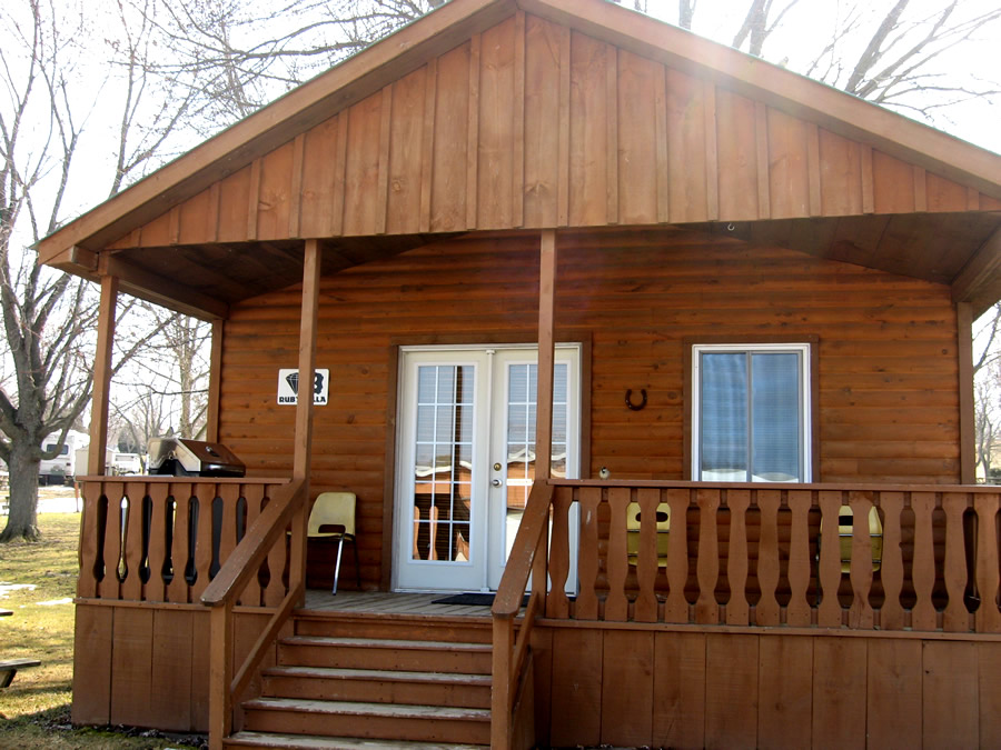 Rustic wood cabin with small veranda